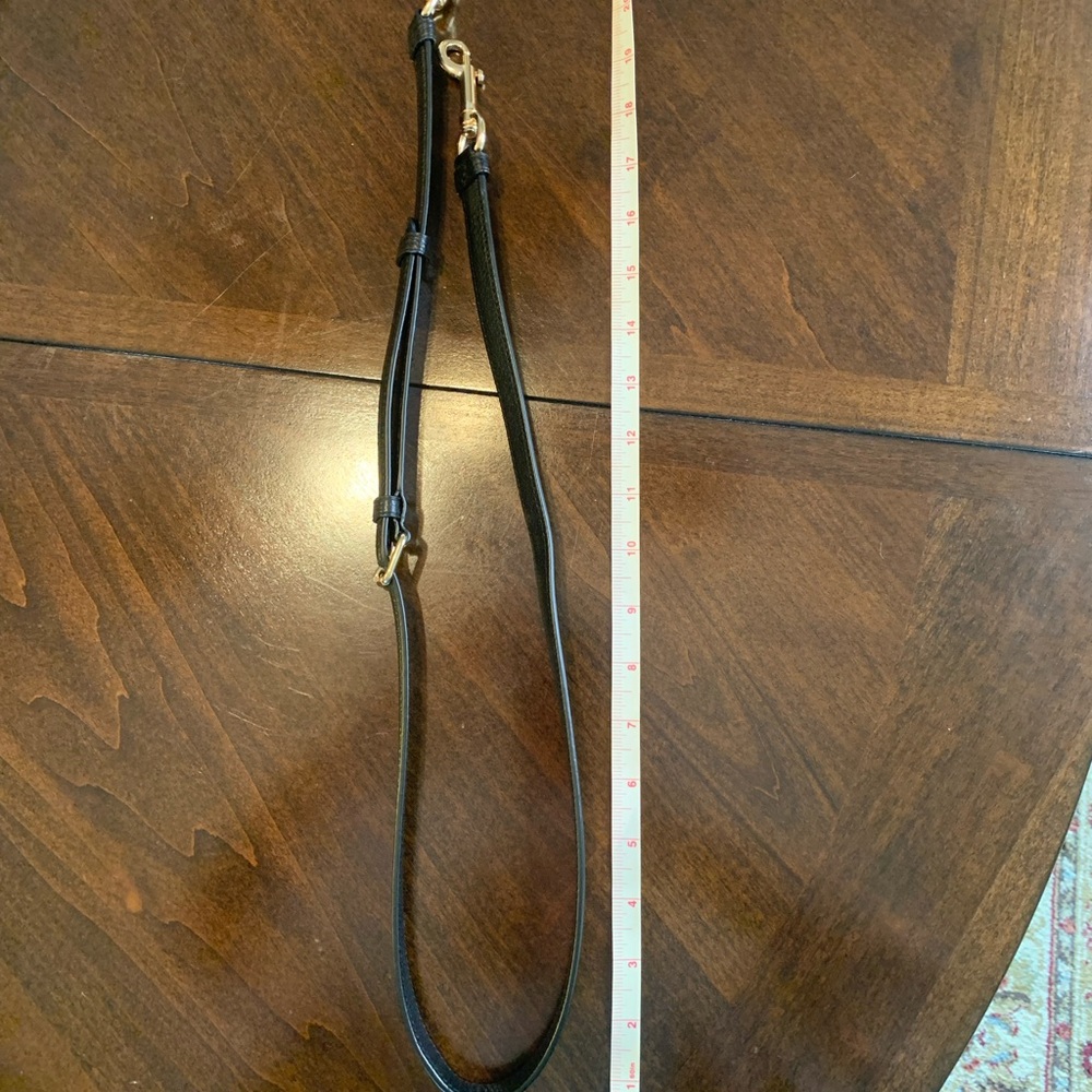 Black leather purse shoulder strap.